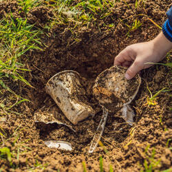 a pile of plastic in dirt