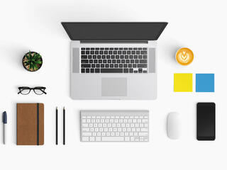laptop and phone workspace from above