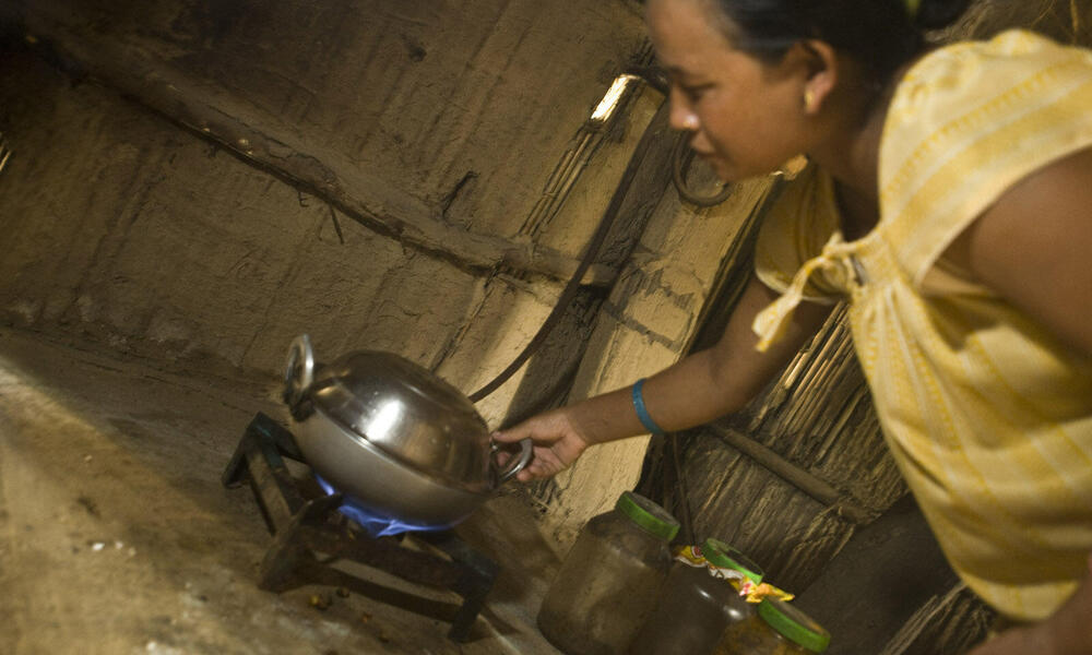 Kinu Darai cooking with bio-gas in her family home.