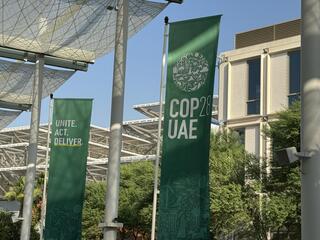 Banners announcing COP28 outside of summit building, Dubai