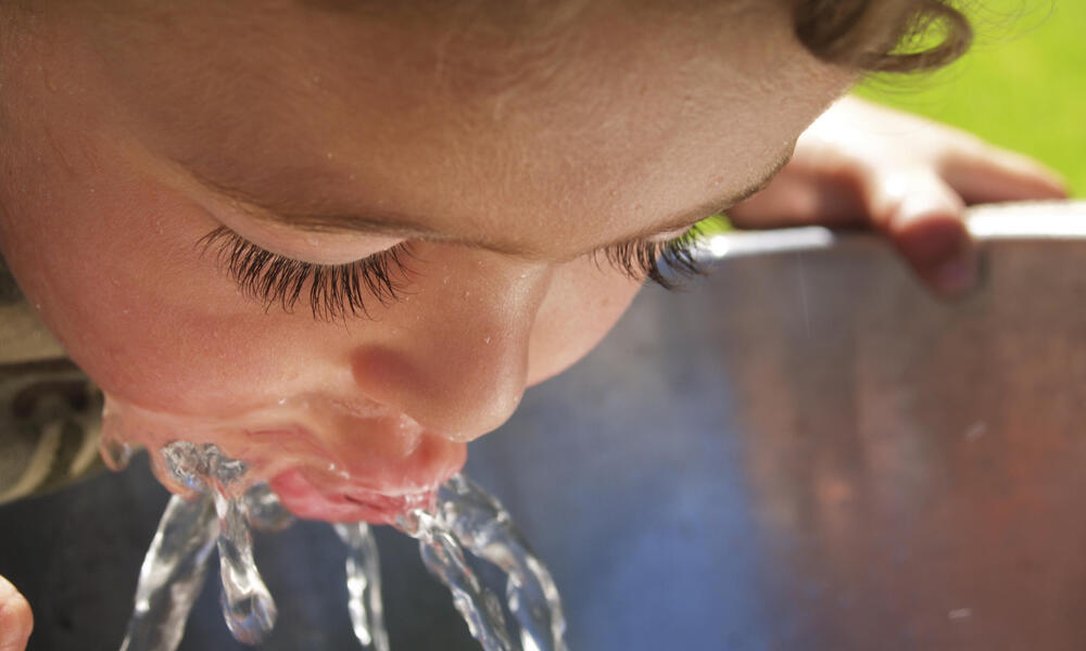 boy drinking from fountain