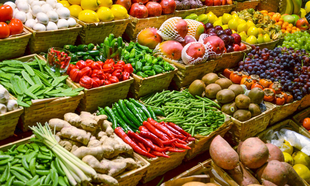 Large display of several rows of fruits and vegetables 