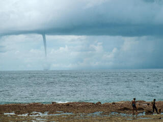 Tornado building from a cyclone over the sea. N.W. monsoon, Indonesia.