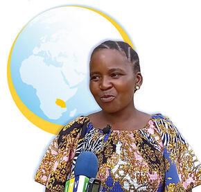 Woman in front of globe showing Tanzania