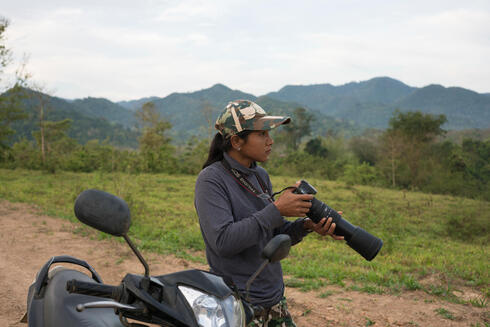 Woraya Makai (34) takes pictures of wild animals during an early morning patrol through the park. She’s the only female ranger deployed in Kui Buri and in charge of photographing and surveying the animals she’s seeing around the park.