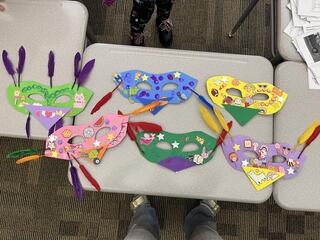 an overhead view of bird masks created by students in Savoonga