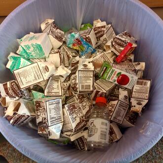 Waste can full of milk cartons