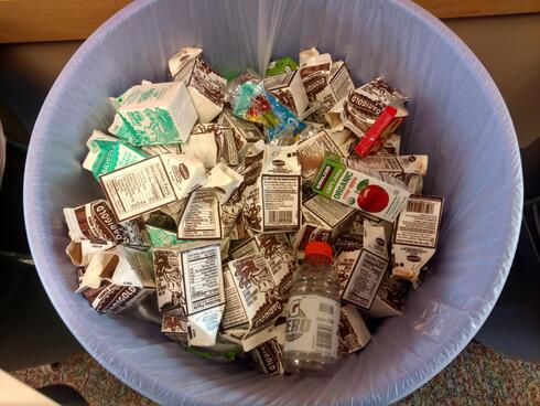 Waste can full of milk cartons