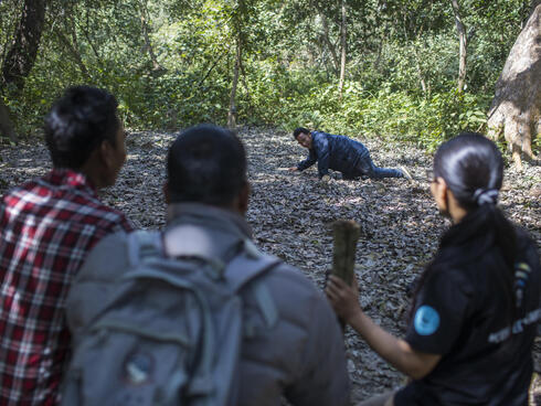 Sabita Malla (front), tiger expert at WWF Nepal, is walking with citizen scientists responsible for monitor tigers in the Khata Corridor.
