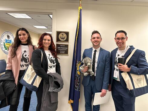 Four Panda Ambassadors stand in the hallway of the U.S. Senate 