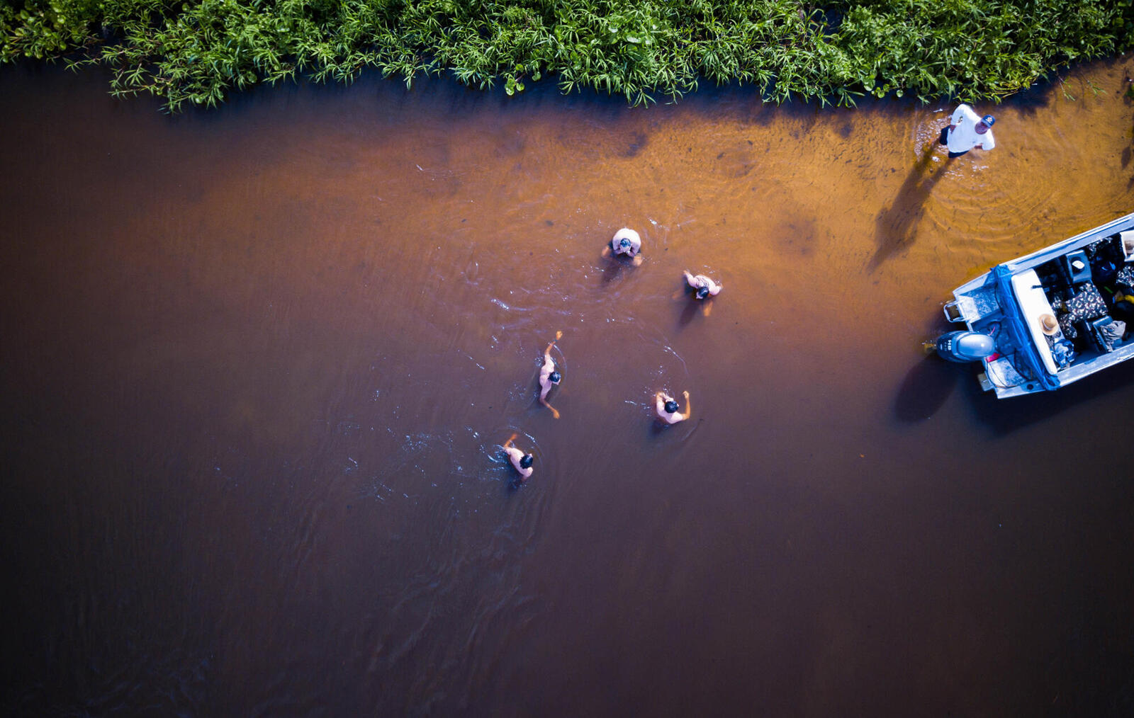 People wading in a river