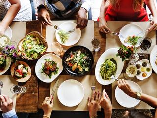 aerial shot of a group of people sitting around a table sharing a meal