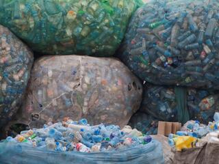 Bags of plastic bottles at a recycling station