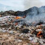 a pile of plastic and trash on fire