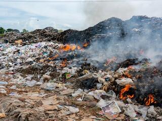 a pile of plastic and trash on fire