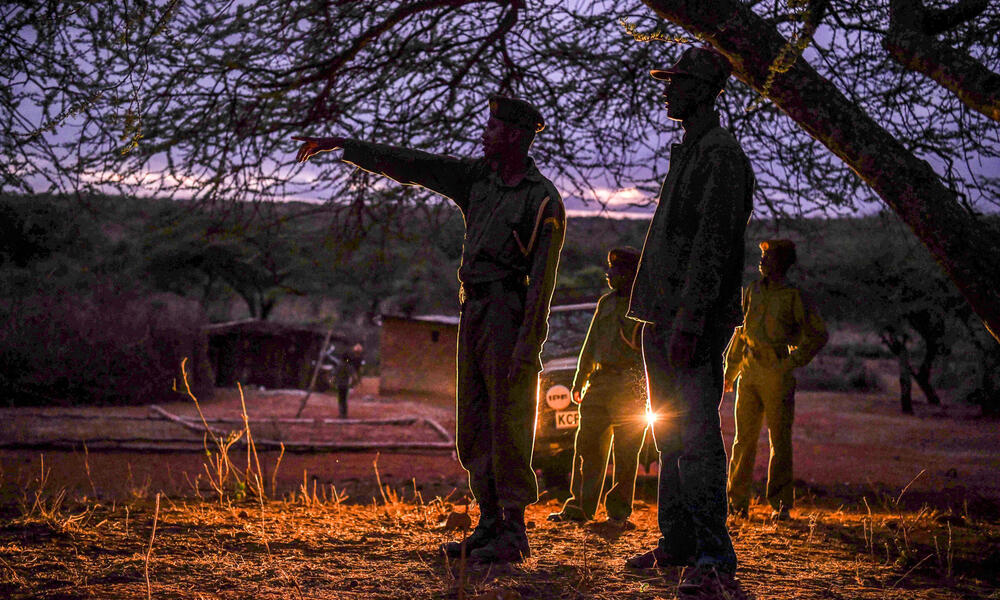 Conservancy rangers Musa, Daniel, Solomon and WWF-Kenya's Peter Loketeler on early morning patrol at Elangata Enderit village in lower Loita, Kenya.