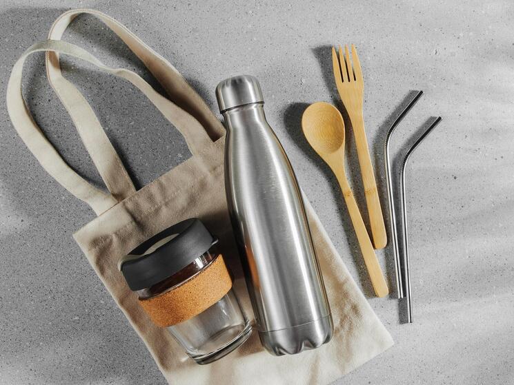 A collection of reusable bags, cups, cutlery