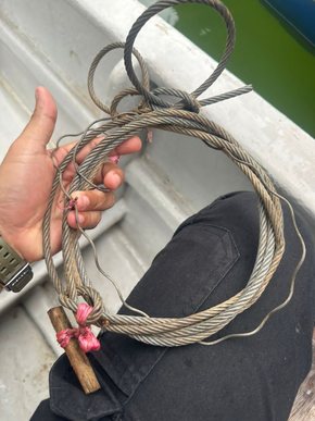 a person holds a recovered snare trap