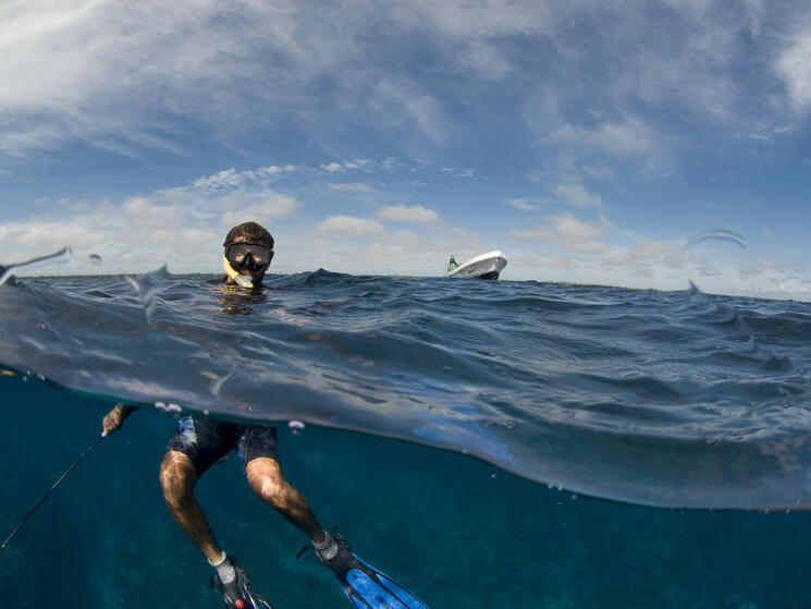 Two men snorkleing underwater