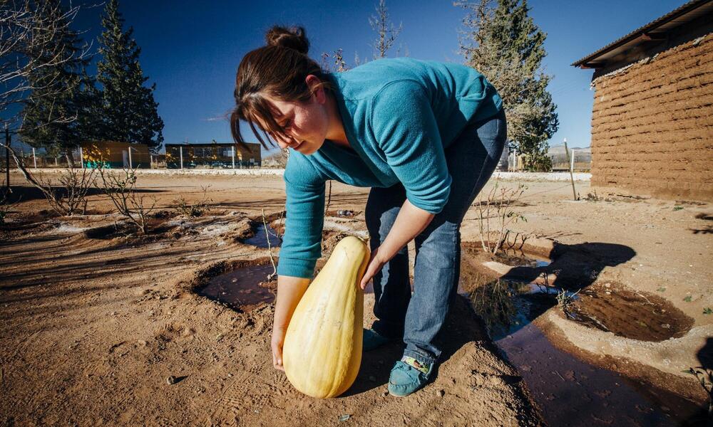 Brenda Márquez shows squash grown with minimal water in the Chihuahuan Desert.