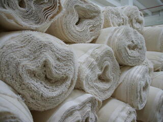 Stacked rolls of fabric