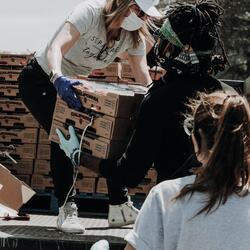 people unloading food from a truck