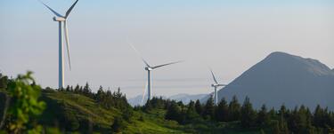 Wind turbines line the top of Pillar Mountain in Kodaik, Alaska
