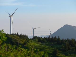 Wind turbines line the top of Pillar Mountain in Kodaik, Alaska