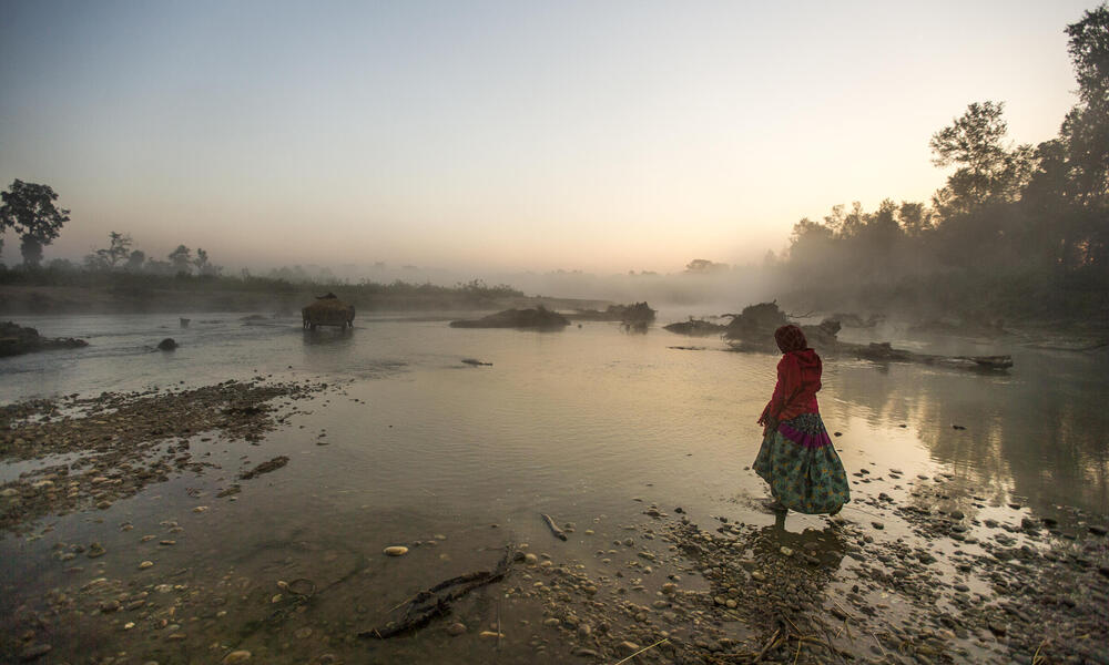 Woman walking through lake in Nepal