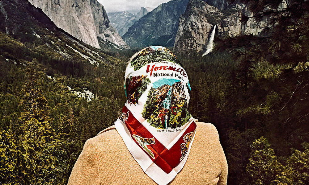 A woman with a Yosemite scarf poses in Yosemite