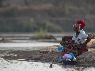 Two women use the river to wash up while avoiding the threat of crocodiles along the Luangwa River.